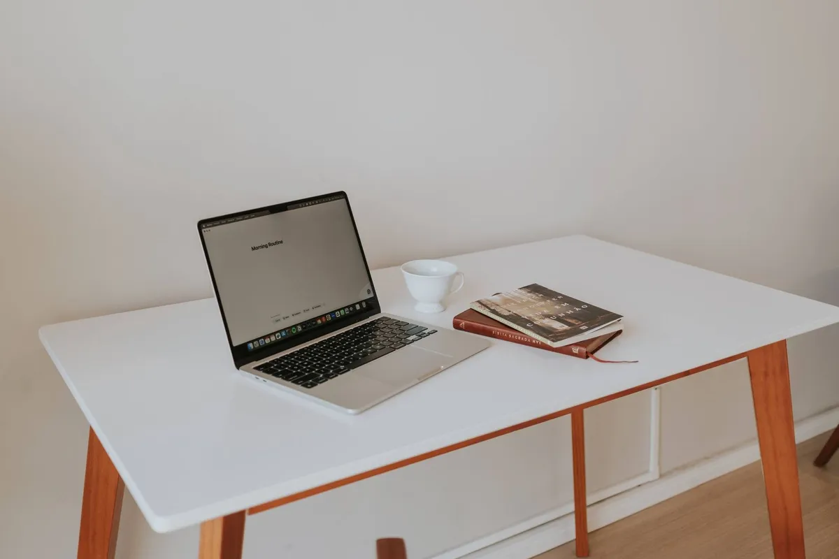 A clean workspace with a laptop, coffee cup, and books, suggesting focus on personal injury claim strategies.
